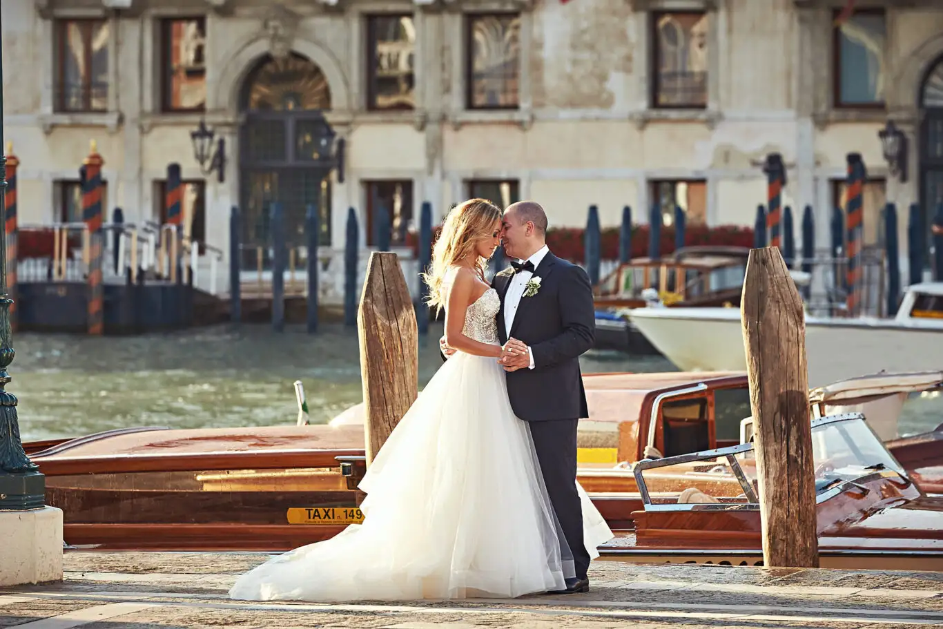 Couple kissing beside the water taxis on the Grand Canal in Venice