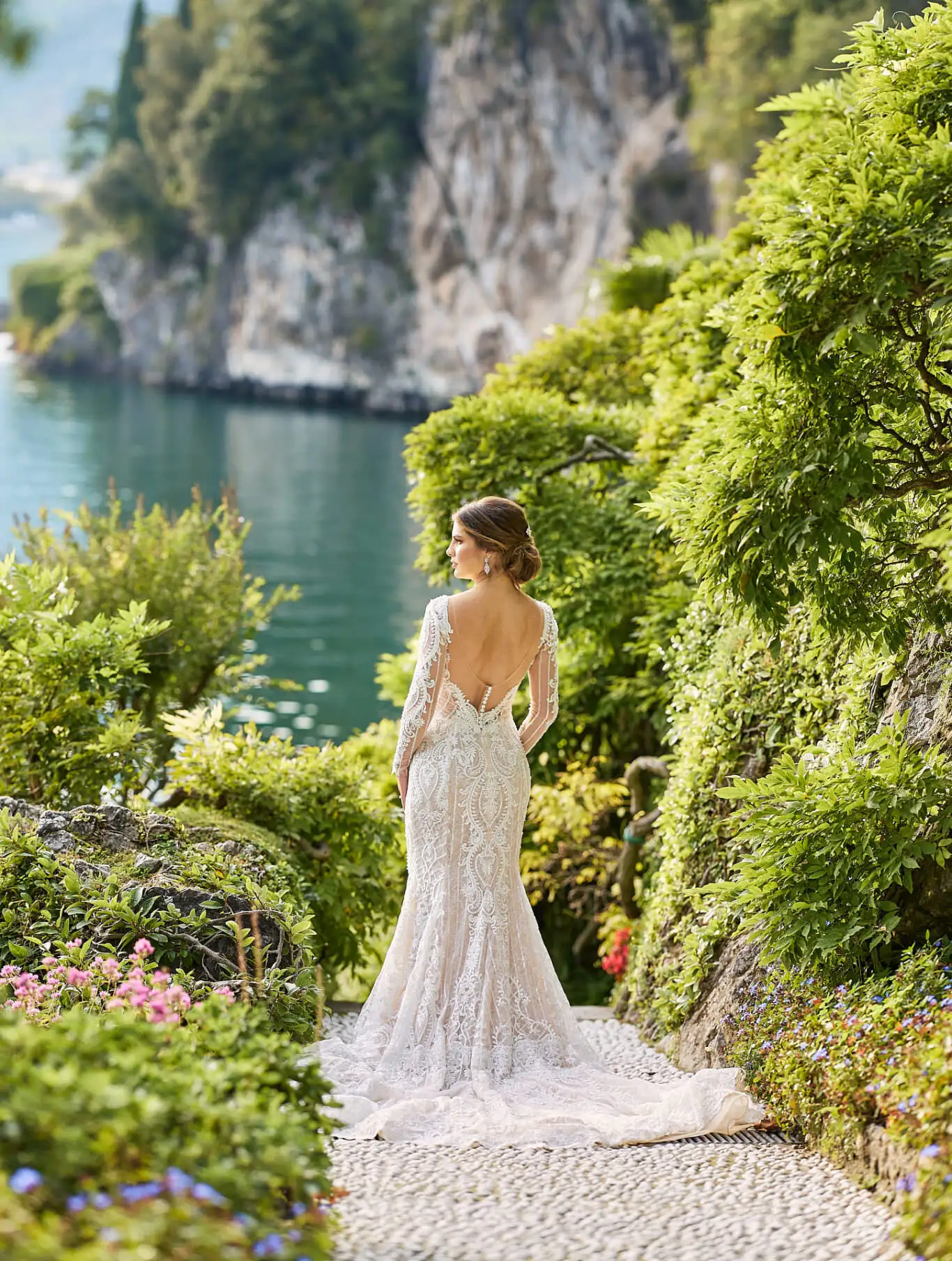 Bride in a lace gown on a garden path at Villa del Balbianello on Lake Como