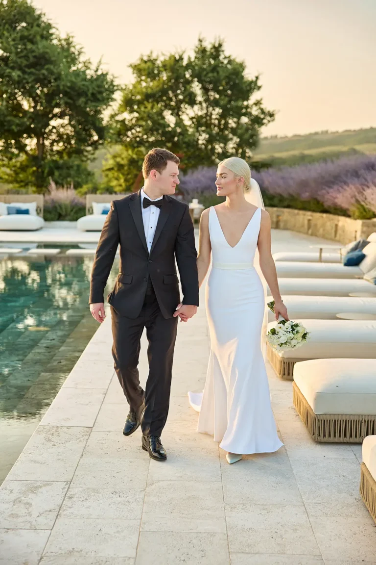 newlyweds walking at sunset